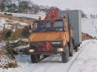 Unimog U1000 towing a cabin to a site in Mid Wales